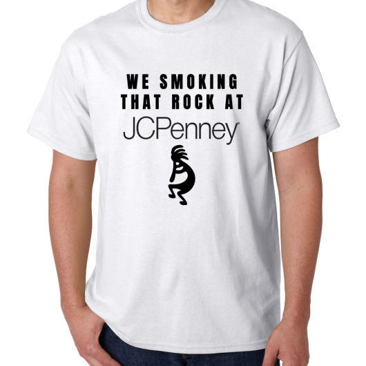 white t-shirt with the text WE SMOKING THAT ROCK AT JCPENNEY. Underneath the JCPENNEY logo is a picture of Kokopelli